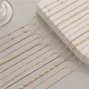 Detailed display of assorted gold chains including bead and cable styles for necklaces