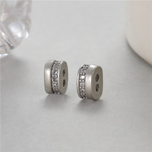 Silver-tone cylindrical stud earrings with pavé zircons and matte finish metal texture