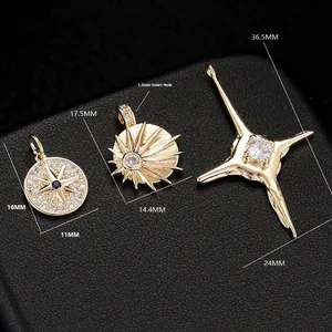 Detailed view of three gold star and compass pendants with blue and white zircon inlays