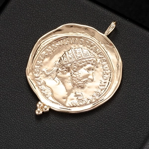 Detailed close-up of 14K gold-filled vintage coin pendant with embossed portrait detail
