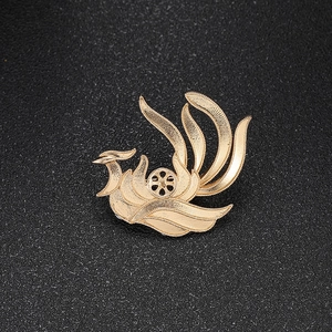 Detail of a brushed gold phoenix brooch with a circular open setting for DIY jewelry