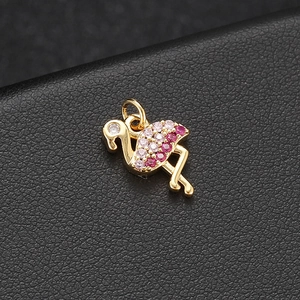 Detailed close-up of a 14K gold flamingo charm featuring pink gradient zircon stones