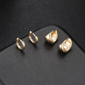 Retro 14k gold plated hoop earrings and thick polished huggies on black leather