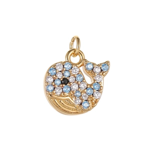 Exquisite whale pendant in 14K gold with blue zircon pavé and shimmering gemstones