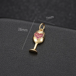 Detailed macro view of 14k gold wine glass pendant with red heart crystals 16x7mm