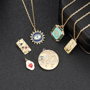 Detailed collection of 18k gold plated evil eye and tarot pendants on black background