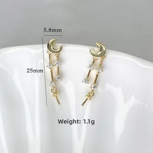 Macro view of gold crescent moon earrings with cubic zirconia drops and size measurements