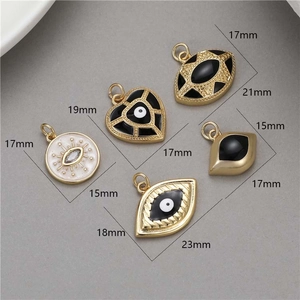 Various 14K gold plated evil eye and heart pendants with size measurements in mm