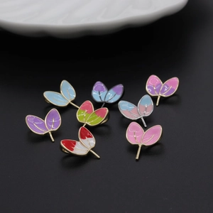 Colorful enamel leaf charms and fan-shaped DIY jewelry components in various vibrant colors