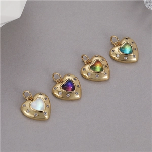 Macro detail of gradient heart pendants with gold plating and sparkling zircon stones