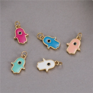Detailed view of colorful enamel Hamsa hand charms with gold plating for DIY jewelry