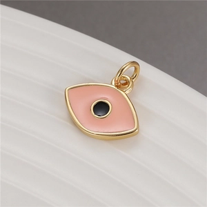 Macro shot of pink and black enamel evil eye pendant charm for jewelry making