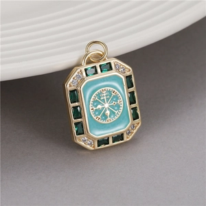 Macro detail of rectangle gold pendant with blue enamel and Nordic Vegvisir compass symbol