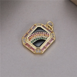 Macro detail of octagonal gold pendant with rainbow gemstones and pink zircon edges