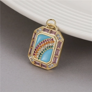 Golden rectangular rainbow pendant with colorful cubic zirconia and light blue enamel
