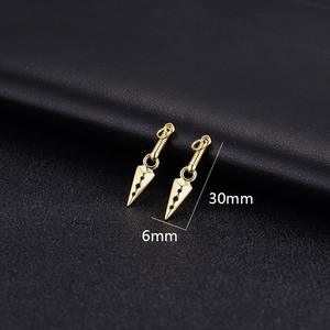 Macro view of 30x6mm 14K gold plated kunai charms with intricate hollow-out patterns