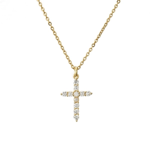 Macro shot of gold hip hop cross pendant featuring sparkling pave-set white cubic zirconia stones
