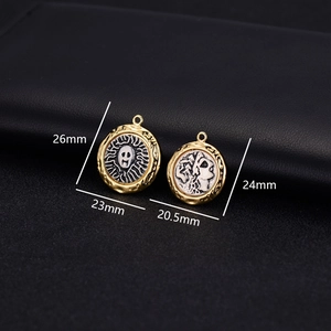 Detailed view of 14k gold vintage skull pendants with size measurements on black leather