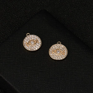 14k gold plated evil eye pendant necklace set with pavé cubic zirconia on black texture