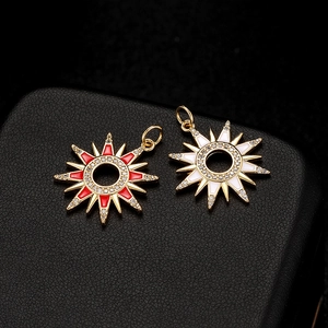 Gold hollow sun pendants with red and white enamel and zircons on black leather