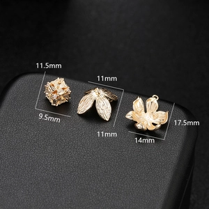 Detail of 14K gold plated flower charms and leaf connectors for DIY jewelry making