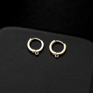 Classic 18K gold-plated hinged hoop earrings with small pendant rings on black leather