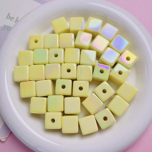 Macro shot of iridescent yellow cubic UV plated beads for DIY handmade jewelry crafting