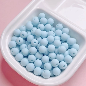 Close-up of light blue matte finish rubberized round beads for DIY jewelry making