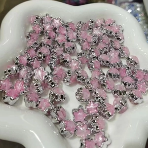 Macro shot of pink acrylic star beads with silver edges for DIY jewelry making