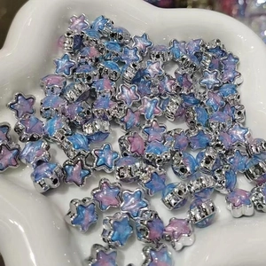 Macro view of star-shaped acrylic beads with silver frames and marble textures for DIY jewelry