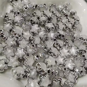 Close-up of silver-edged acrylic star beads with pearlescent center for DIY jewelry making