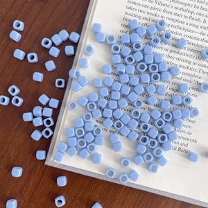 Detail of light blue square acrylic macaron beads with large holes for DIY crafts