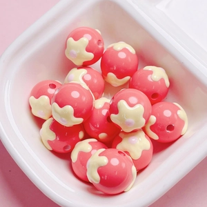 Detailed view of pink resin flower beads in a bowl for DIY jewelry and phone chains
