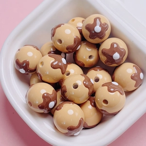 Macro detail of cute Takoyaki resin beads for DIY jewelry and phone chain making