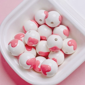 Detailed view of hand-painted floral heart round beads for DIY jewelry and phone chains