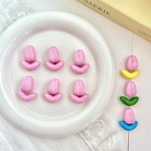 Macro shot of glossy pink tulip beads with colorful leaves for DIY jewelry making