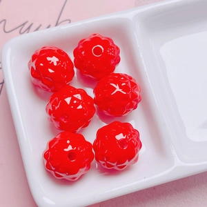 Macro shot of red flower-shaped acrylic beads with detailed wavy texture for DIY jewelry making