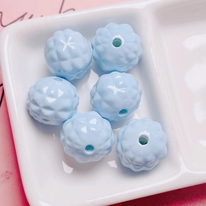 Macro shot of light blue acrylic pineapple beads with geometric texture for DIY jewelry