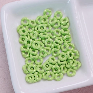 Macro shot of light green scalloped flower spacer beads for DIY jewelry making