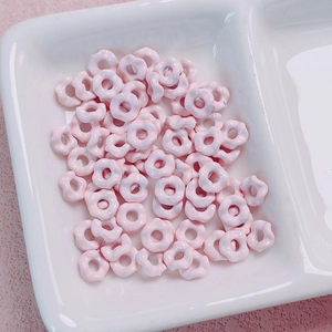 Macro shot of cute light pink wave edge flower beads for DIY phone chains and accessories
