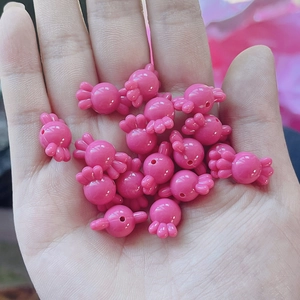 Detalle de cuentas acrílicas rosas en forma de caramelo para bisutería hecha a mano DIY
