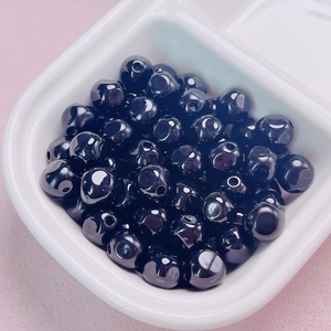 Close-up of 10mm glossy black acrylic beads for DIY jewelry and phone chain making