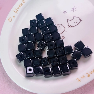 Close-up of 12mm black acrylic square cube beads for DIY jewelry making and crafts