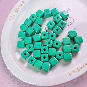Detail of mint green 12mm acrylic cube beads with hole for DIY jewelry making
