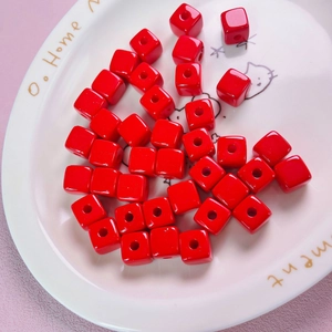 Macro shot of 12mm red acrylic macaron cube beads for DIY jewelry making and phone charms