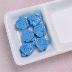 Macro detail of blue 3D cartoon girl beads for DIY phone chains and jewelry making