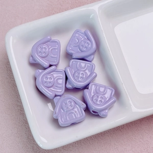 Detailed view of light purple house-shaped acrylic beads with smiling faces for DIY crafts