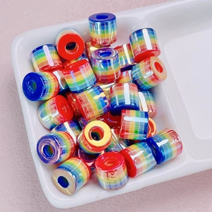 Close-up of colorful striped cylindrical resin beads for DIY jewelry making and crafts