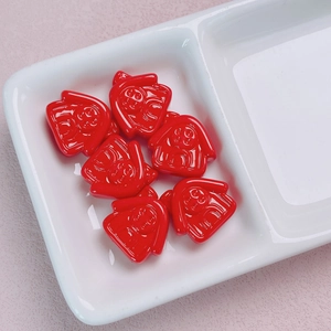 Macro detail of red 3D Darth Vader style DIY charms in a white ceramic organizer tray