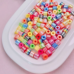 Colorful striped resin cylinder beads for DIY jewelry making in a white tray